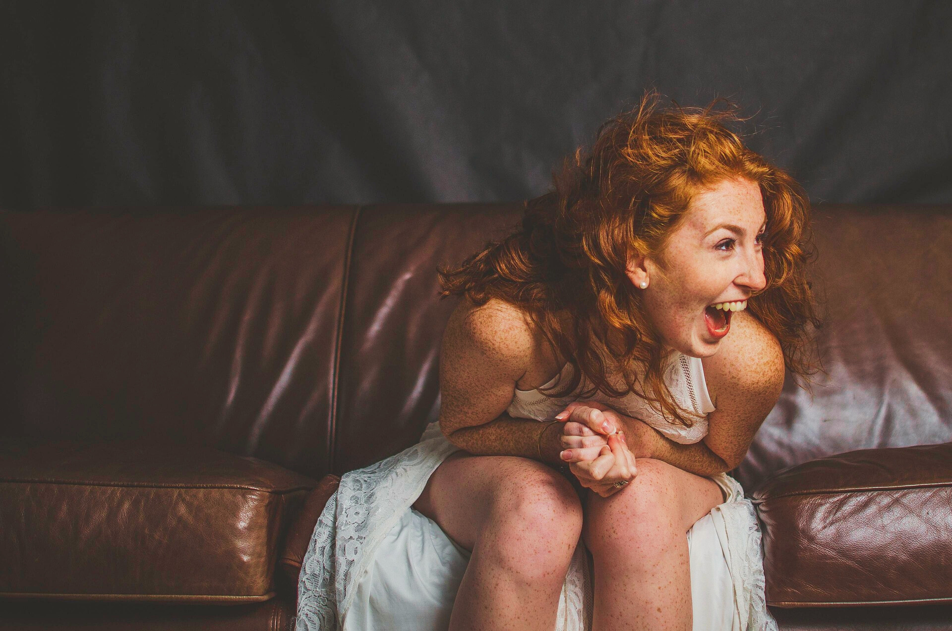 Laughing woman sitting on a sofa